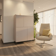 Laden Sie das Bild in den Galerie-Viewer, Design Highboard Case von Kettnaker, stilvolles Möbel mit vier Türen und klaren Linien in Wohnumgebung mit dem Relaxsessel Daron von den Bielefelder Werkstätten