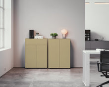 Laden Sie das Bild in den Galerie-Viewer, Harmonische Sideboard-Kombination aus zwei Kommoden in eleganter Taupe-Farbe – Piure Nex Pur Box 2041100 mit 2 Türen und 2041300 mit zusätzlichem Schubkasten, präsentiert in einem hellen Interior mit Betonboden