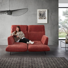 Laden Sie das Bild in den Galerie-Viewer, Frau entspannt auf dem verstellbaren Relaxsofa Meda – das Sofa zeigt sich mit individuell geöffnetem Sitz- und Fußteil, ideal für Lesepausen und digitale Auszeiten.