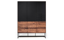 Laden Sie das Bild in den Galerie-Viewer, Design Geschirrschrank Alleskönner von Scholtissek aus Nussbaum Massivholz mit schwarzen Glastüren und vier Schubladen, Vorderansicht
